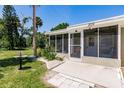 Home exterior showcasing screened porch and landscaping at 2112 Mark Ave, Punta Gorda, FL 33950