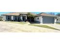 House exterior showcasing a well-maintained front yard and driveway at 98 Seasons Dr, Punta Gorda, FL 33983