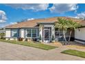 Close up of home's front entry, featuring lovely plants and manicured landscaping at 98 Seasons Dr, Punta Gorda, FL 33983