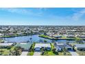 Aerial view of waterfront home with canal access and lush landscaping in a residential community at 355 Belaire Ct, Punta Gorda, FL 33950