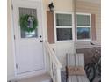 Front door entrance with wreath, porch seating, and bikes at 6603 Hauli Ct, North Port, FL 34287