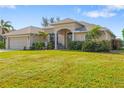 One story house with a two car garage and lush green lawn at 219 White Marsh Ln, Rotonda West, FL 33947