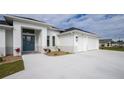 White two-story house with a two-car garage and manicured landscaping at 425 Orinoco St, Punta Gorda, FL 33983