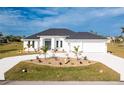 White two-story house with a two-car garage and manicured landscaping at 425 Orinoco St, Punta Gorda, FL 33983