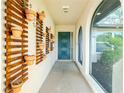 Inviting entryway with decorative plant shelves and a stylish teal front door at 1190 Victoria Ave Nw, Port Charlotte, FL 33948