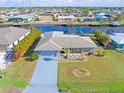 Bird's-eye view of a house by the waterfront, showcasing its surroundings at 138 Peckham Sw St, Port Charlotte, FL 33952