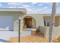 Inviting front entry with arched doorway and charming landscaping at 138 Peckham Sw St, Port Charlotte, FL 33952