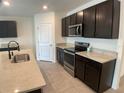 Spacious kitchen with dark wood cabinets, stainless steel appliances, and granite countertops at 2201 Grand Flora Trl, Bradenton, FL 34208