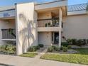 Condo building exterior featuring a walkway and landscaping at 3256 White Ibis Ct # 22A, Punta Gorda, FL 33950