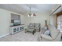 Bright living room with vaulted ceilings, comfy sofas, and a large TV at 4485 Herder St, Port Charlotte, FL 33948