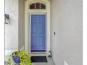 Inviting front entrance with a vibrant purple door at 1796 Scarlett Ave, North Port, FL 34289