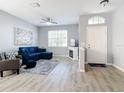 Bright living room featuring a comfortable sectional sofa and a modern fireplace at 1796 Scarlett Ave, North Port, FL 34289