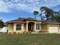 One-story home with a brown roof, attached garage, and attractive landscaping at 3100 Sheboygan Ave, North Port, FL 34286