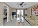 Spacious living room with access to a patio and lake view at 25225 Rampart Blvd # 1901, Punta Gorda, FL 33983