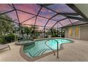 Relaxing screened pool and spa area with water view at 3706 Whippoorwill Blvd, Punta Gorda, FL 33950