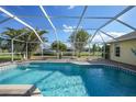 Relaxing screened-in pool area with a view of the surrounding landscape at 221 Sportsman Rd, Rotonda West, FL 33947