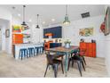 Beach-themed kitchen with orange appliances and a wooden table at 28492 Royal Palm Dr, Punta Gorda, FL 33982