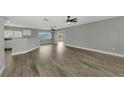 Spacious living room with gray walls and wood-look tile floor at 3324 Avanti Cir, North Port, FL 34287