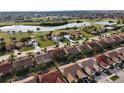 Aerial view of community showing home's location near golf course and lake at 3820 Tripoli Blvd # 42, Punta Gorda, FL 33950