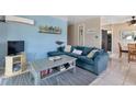 Cozy living room featuring a teal sectional sofa and coffee table at 3999 Conway Blvd, Port Charlotte, FL 33952