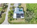 House with solar panels and pool, viewed from above at 4132 Michel Tree St, Port Charlotte, FL 33948