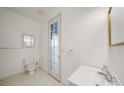 Simple bathroom with toilet, sink, and frosted glass door at 4132 Michel Tree St, Port Charlotte, FL 33948