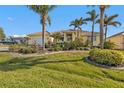 Bright yellow house with mature landscaping and palm trees at 4315 Cape Haze Dr, Placida, FL 33946