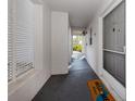 Condo entry with gray door, welcome mat, and light-filled hallway at 437 Cerromar Ln # 312, Venice, FL 34293