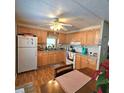 Bright kitchen with wood cabinets, and laminate flooring at 525 Parkwood Ave, North Port, FL 34287