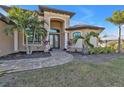 Welcoming front entry with a paved walkway and lush landscaping at 13449 Palau Cir, Port Charlotte, FL 33953