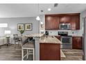 Granite kitchen island with stainless steel appliances at 2061 Willow Hammock Cir # 204, Punta Gorda, FL 33983