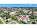 Aerial showing condo community, pool, tennis courts, and water views at 255 W End Dr # 2412, Punta Gorda, FL 33950