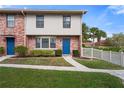 Brick townhome with blue doors and landscaped yard at 3335 Purple Martin Dr # 1, Punta Gorda, FL 33950