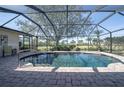 Relaxing screened-in pool area with brick pavers at 7529 Coral Tree, Punta Gorda, FL 33955