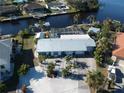 Home with metal roof, driveway, lush landscaping, backyard pool, and canal in the backyard at 193 N Waterway Nw Dr, Port Charlotte, FL 33952