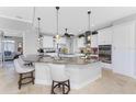 Modern kitchen with white cabinets, granite countertops, and island seating at 386 Royal Poinciana, Punta Gorda, FL 33955