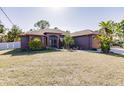 Single-story home with a gray exterior, orange accents, and a well-manicured lawn at 5188 Balmor Ter, North Port, FL 34288