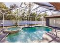 Relaxing kidney-shaped pool with a spa and screened enclosure at 5188 Balmor Ter, North Port, FL 34288