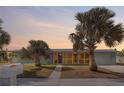 Light blue single story home with palm trees and screened porch at 174 Severin Se Rd, Port Charlotte, FL 33952