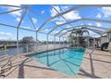 Relaxing pool and patio area with water views at 1120 La Palma Ct, Punta Gorda, FL 33950