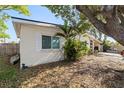 Side view of house with large tree and canoe at 22158 Marshall Ave, Port Charlotte, FL 33952