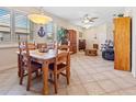 Bright dining area with a wooden table and chairs, adjacent to the living room at 25554 Prada Dr, Punta Gorda, FL 33955