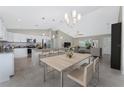 Open-concept kitchen featuring stainless steel appliances, a breakfast bar, and bright lighting at 6356 Opa Locka Ln, North Port, FL 34291