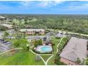 Aerial view of condo community with pool and parking at 1515 Forrest Nelson Blvd # D207, Port Charlotte, FL 33952