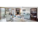 Bright living room with fireplace, comfy seating, and a bookcase at 22278 Vick St # A100, Punta Gorda, FL 33980