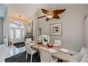 Bright dining room featuring a wood table and ceiling fan at 23176 Lindale Ave, Port Charlotte, FL 33954