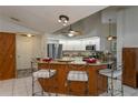 Modern kitchen with stainless steel appliances and breakfast bar at 23176 Lindale Ave, Port Charlotte, FL 33954