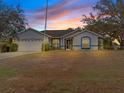 Attractive single-story home showcasing curb appeal at sunset at 2606 Trilby Ave, North Port, FL 34286