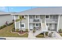 Condo building aerial view, showing landscaping and parking at 3310 Loveland Blvd # 701, Punta Gorda, FL 33980