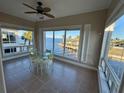 Bright dining area with waterfront views features a glass-top table and tile flooring at 1 Colony Point Dr # 3C, Punta Gorda, FL 33950